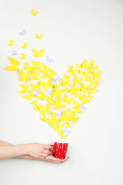 Paper yellow butterfly in form of heart fly out cup