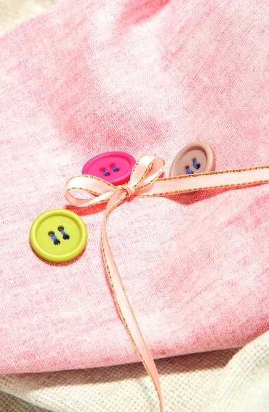 Three buttons on light cloth