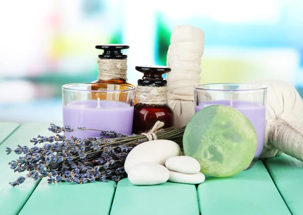 Still life with lavender candle, soap, massage balls, soap and fresh lavender, on bright background
