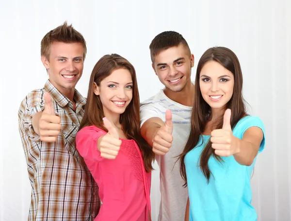 Group of happy beautiful young people at room