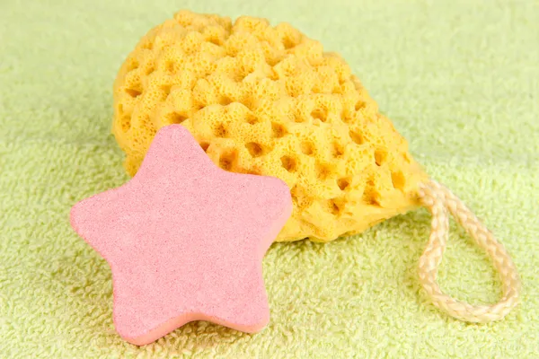 Sea salt and sponge for bathing, on color towel background