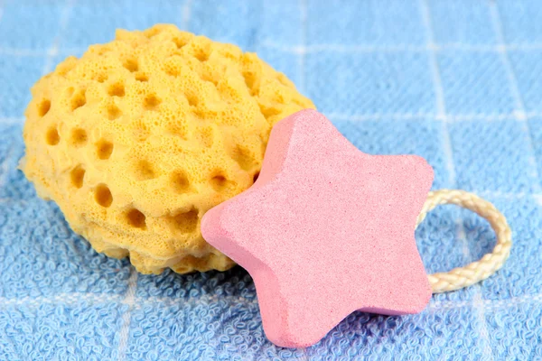 Sea salt and sponge for bathing, on color towel background