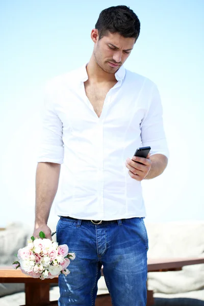 Handsome with bouquet of roses man waiting a woman
