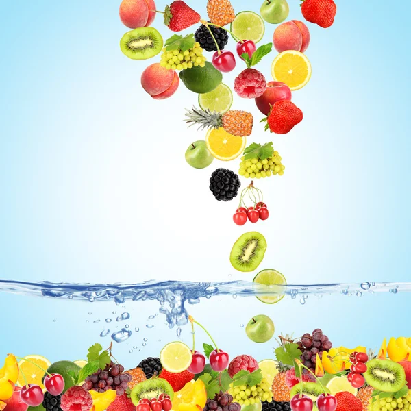 Flight fruits and berries in water on blue background