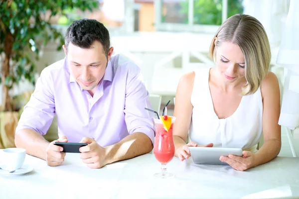 Young couple taking with tablet in restaurant