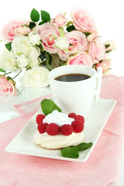 Tasty meringue cake with berries and cup of coffee
