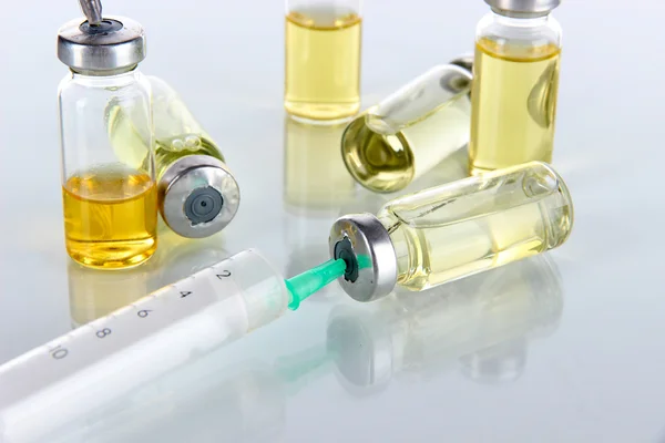 Medical bottles and syringes isolated on white