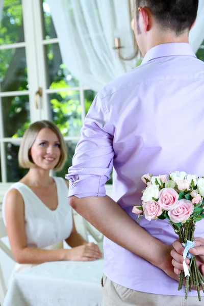 Handsome man with bouquet roses for his girlfriend