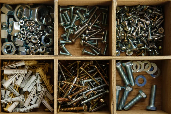 Wooden box for metal bolts, screws and nuts close up