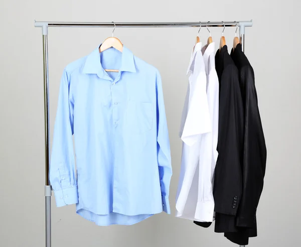 Office male clothes on hangers, on gray background