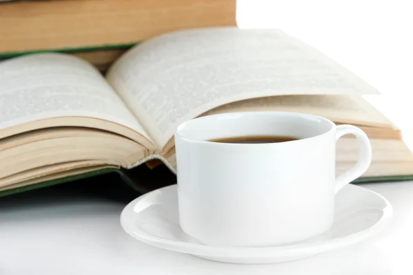 Cup of coffee and books close up