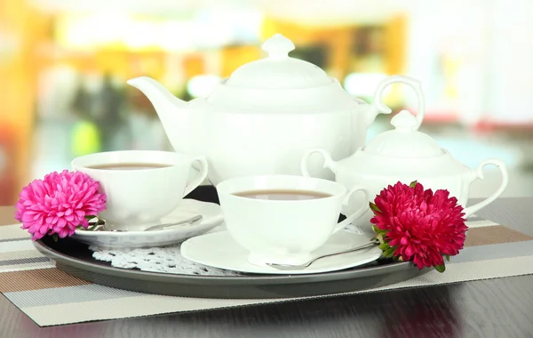 Cups of tea on tray on table in cafe