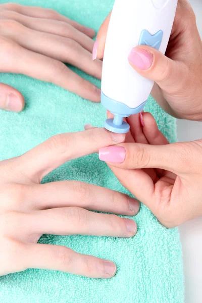 Man doing manicure in salon