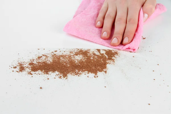 Hand wiping surface with pink rag