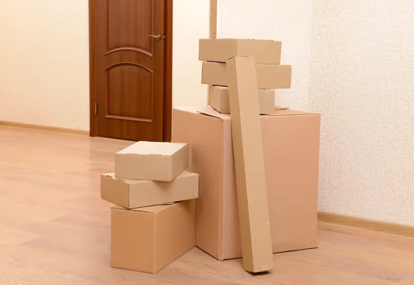 Empty room with stack of cartons: moving house concept