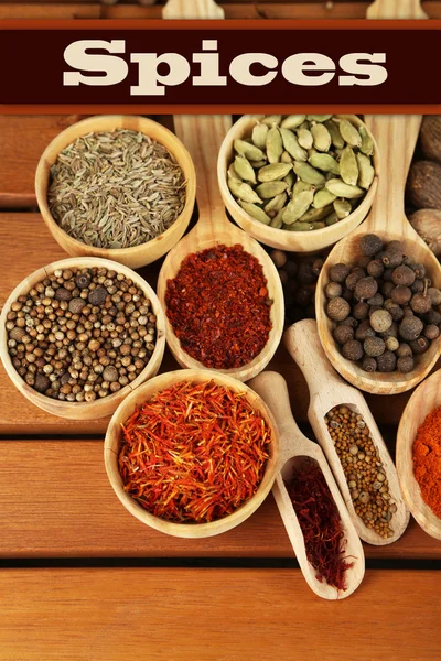 Many different spices and fragrant herbs on wooden table close-up