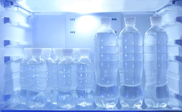 Bottles with water in refrigerator