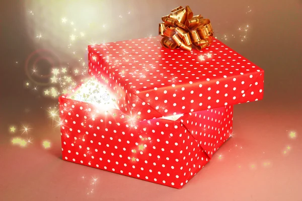 Gift box with bright light on it on bright background