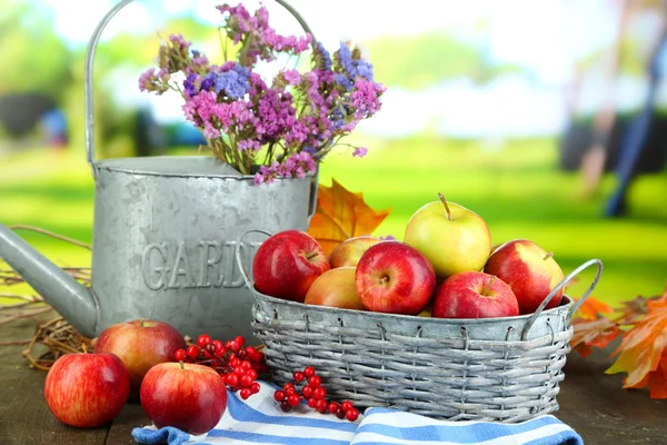 Juicy apples in basket on table on natural background — Stock Photo #35995237