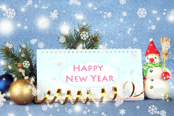 Calendar, New Year decor and fir tree on blue background