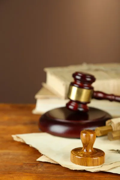 Wooden stamp, gavel and old papers on wooden table