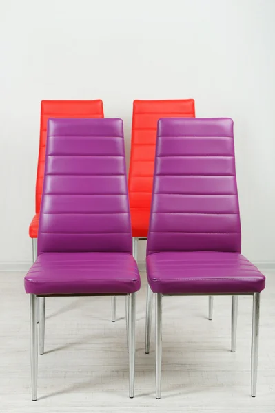 Modern color chairs on wall background