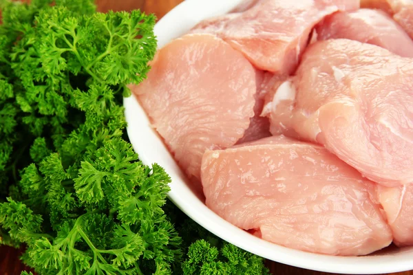 Raw turkey meat on wooden table close up