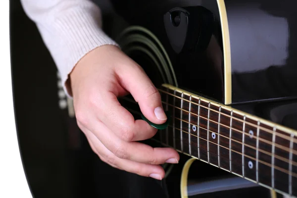 Acoustic guitar in female hands, close-up