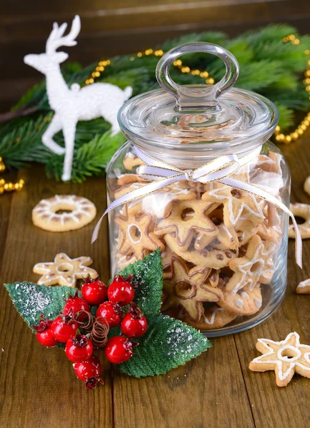 Delicious Christmas cookies in jar on table close-up