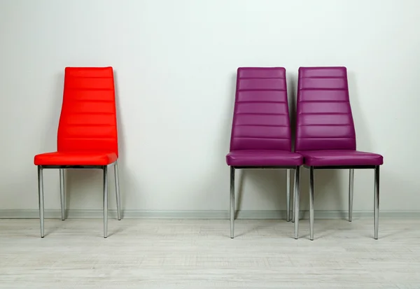 Modern color chairs on wall background