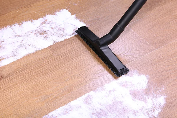 Vacuuming floor in house
