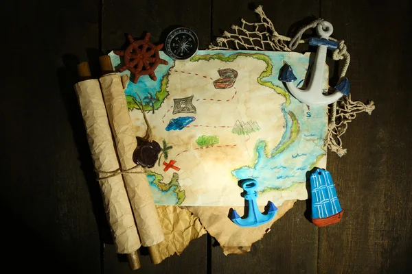 Treasure map with sea accessories, on wooden background