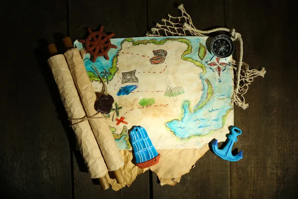 Treasure map with sea accessories, on wooden background