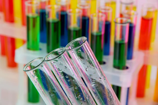 Empty and colorful test tubes close-up