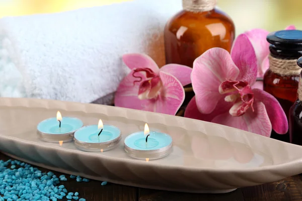 Beautiful spa setting with flower on bright background