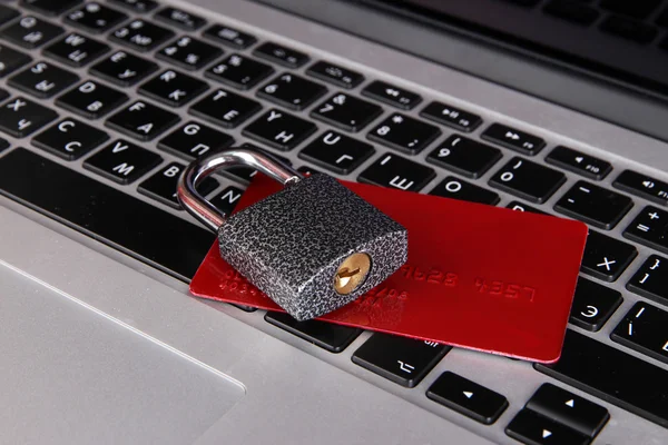 Credit card and lock on keyboard close up