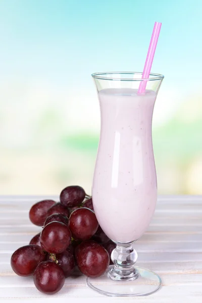 Milk shake on table on light blue background