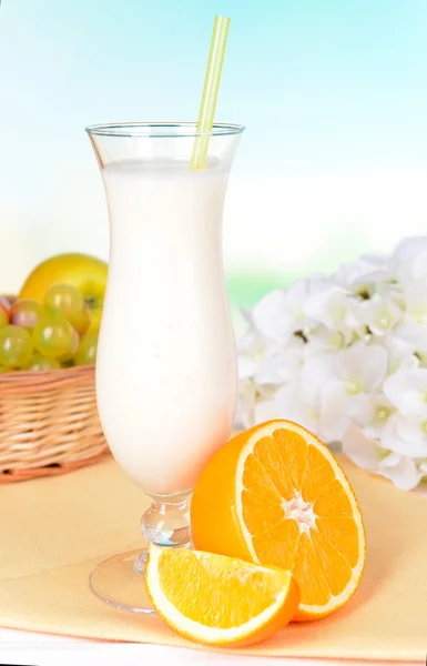 Milk shake on table on light blue background