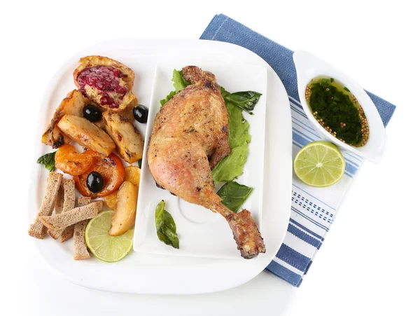 Homemade fried chicken drumsticks with vegetables on plate isolated on white