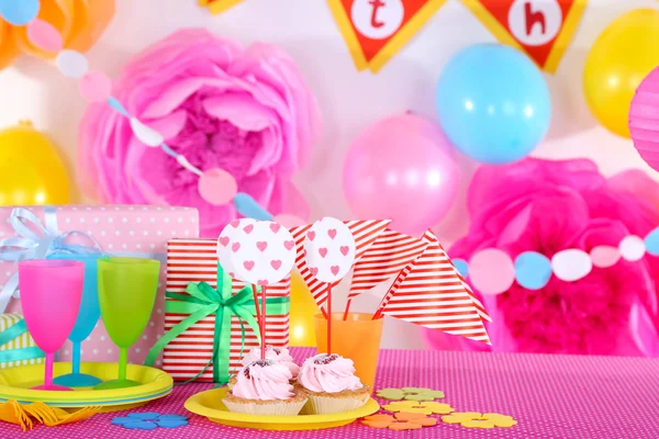 Festive table setting for birthday on celebratory decorations