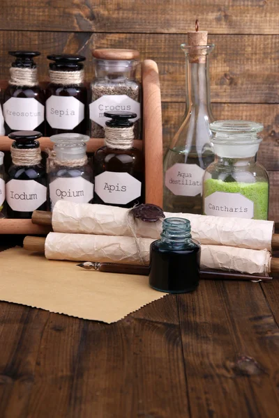 Composition with empty page and historic old pharmacy bottles with label   on wooden background