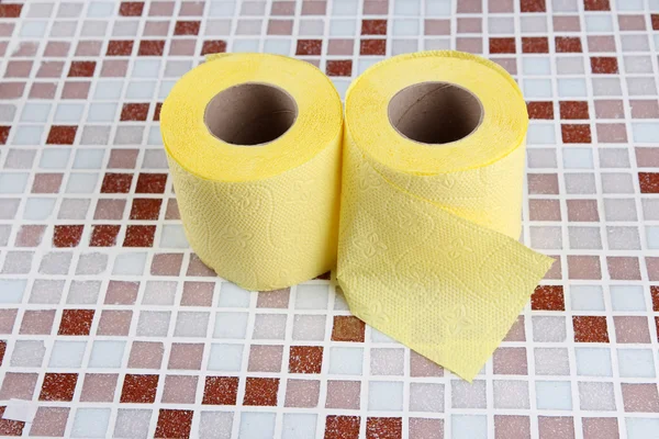 Color toilet paper rolls on bright background