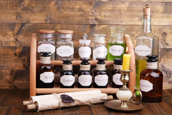 Historic old pharmacy bottles with label on wooden background