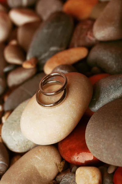 Wedding rings on rocks close-up