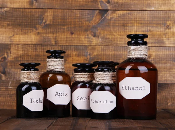 Historic old pharmacy bottles with label on wooden background