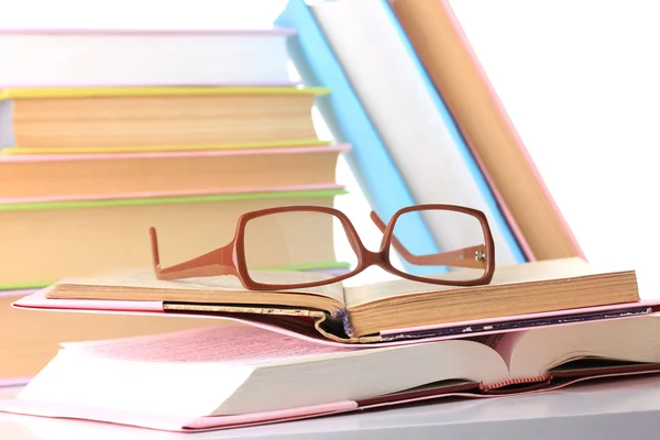 Composition with glasses and books, isolated on white