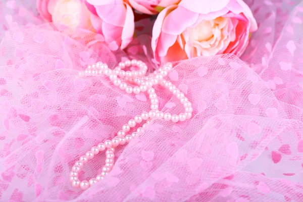 Beautiful pearls on pink cloth