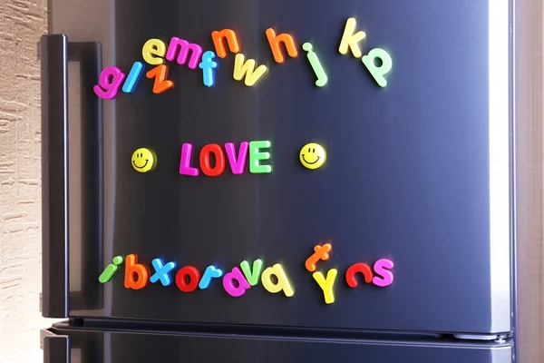 Word Love spelled out using colorful magnetic letters on refrigerator