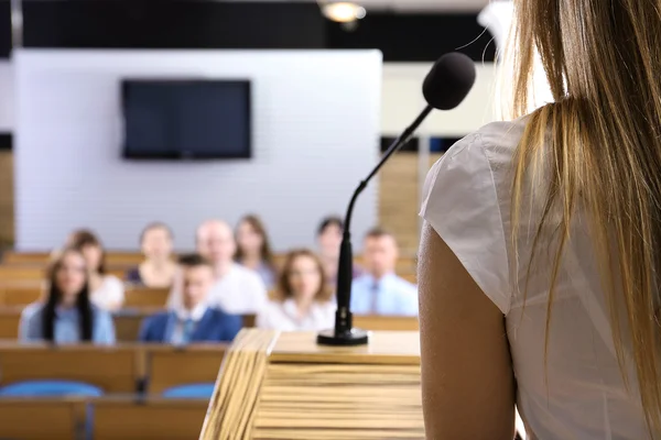 Businesswoman is making speech at conference room