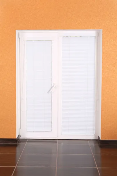 White plastic door with closed blinds